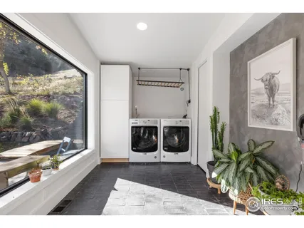 a living room with a large window and a fireplace