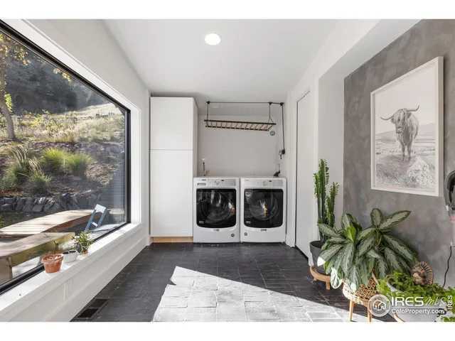 a living room with a large window and a fireplace