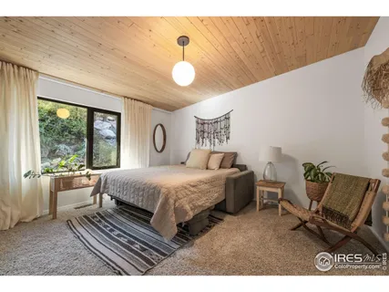 a bedroom with a bed chair and window