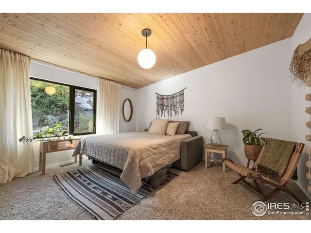 a bedroom with a bed chair and window