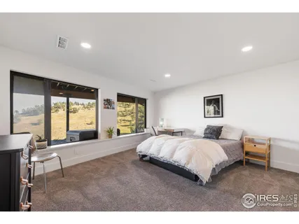 a spacious bedroom with a large bed and a large window