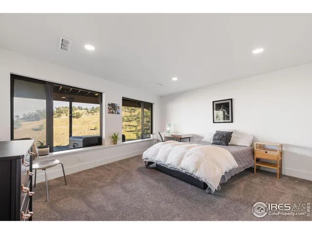 a spacious bedroom with a large bed and a large window