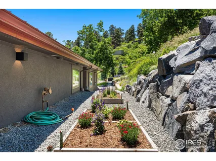 a view of a backyard with garden and patio