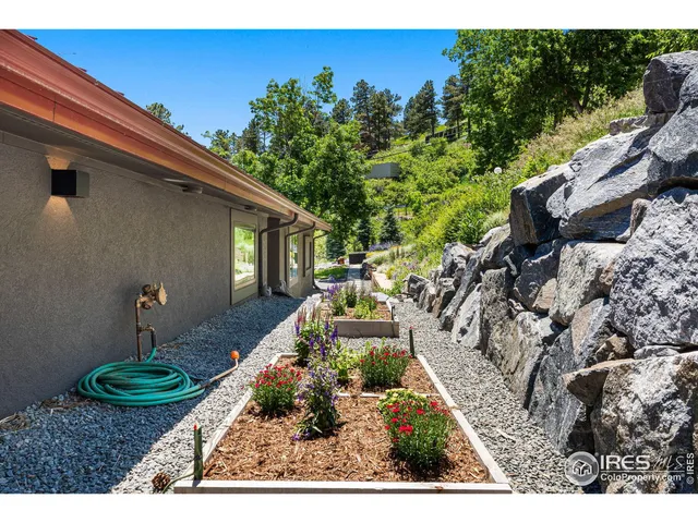 a view of a backyard with garden and patio