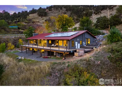 a view of a house with swimming pool and sitting area