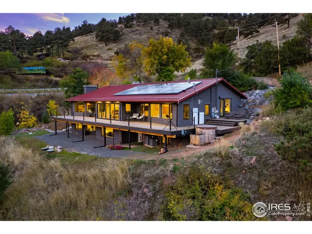 a view of a house with swimming pool and sitting area