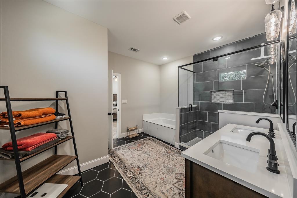 117 Rock Salt Drive Springtown, TX 76082 - Photo 20 of 38 Bathroom featuring hexagon floor tile, a dual vanity with rectangular undermount sinks, and a walk-in shower with dark tile surround and built-in niches