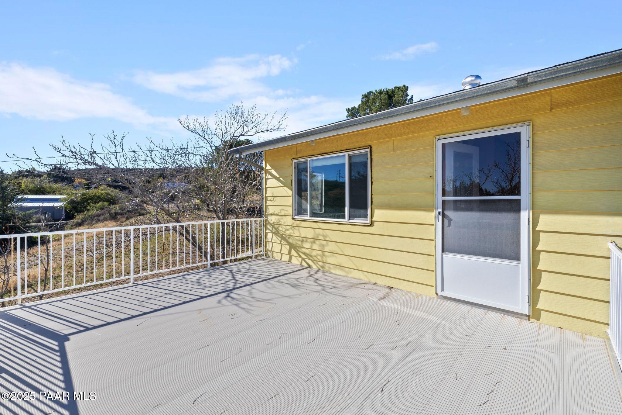 10231 Fir Street Mayer, AZ 86333 - Photo 13 of 50 a view of a balcony with wooden floor and fence
