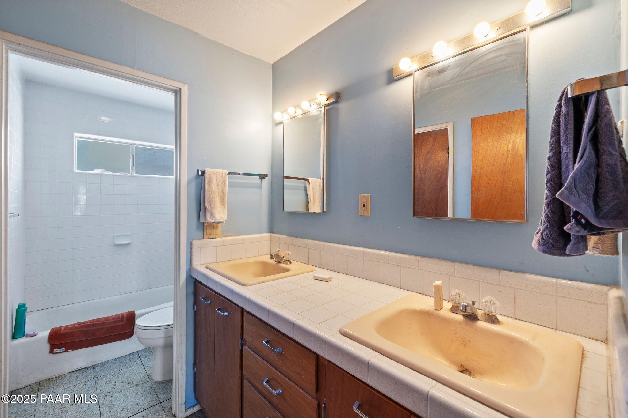 10231 Fir Street Mayer, AZ 86333 - Photo 16 of 50 a bathroom with a tub sink and mirror
