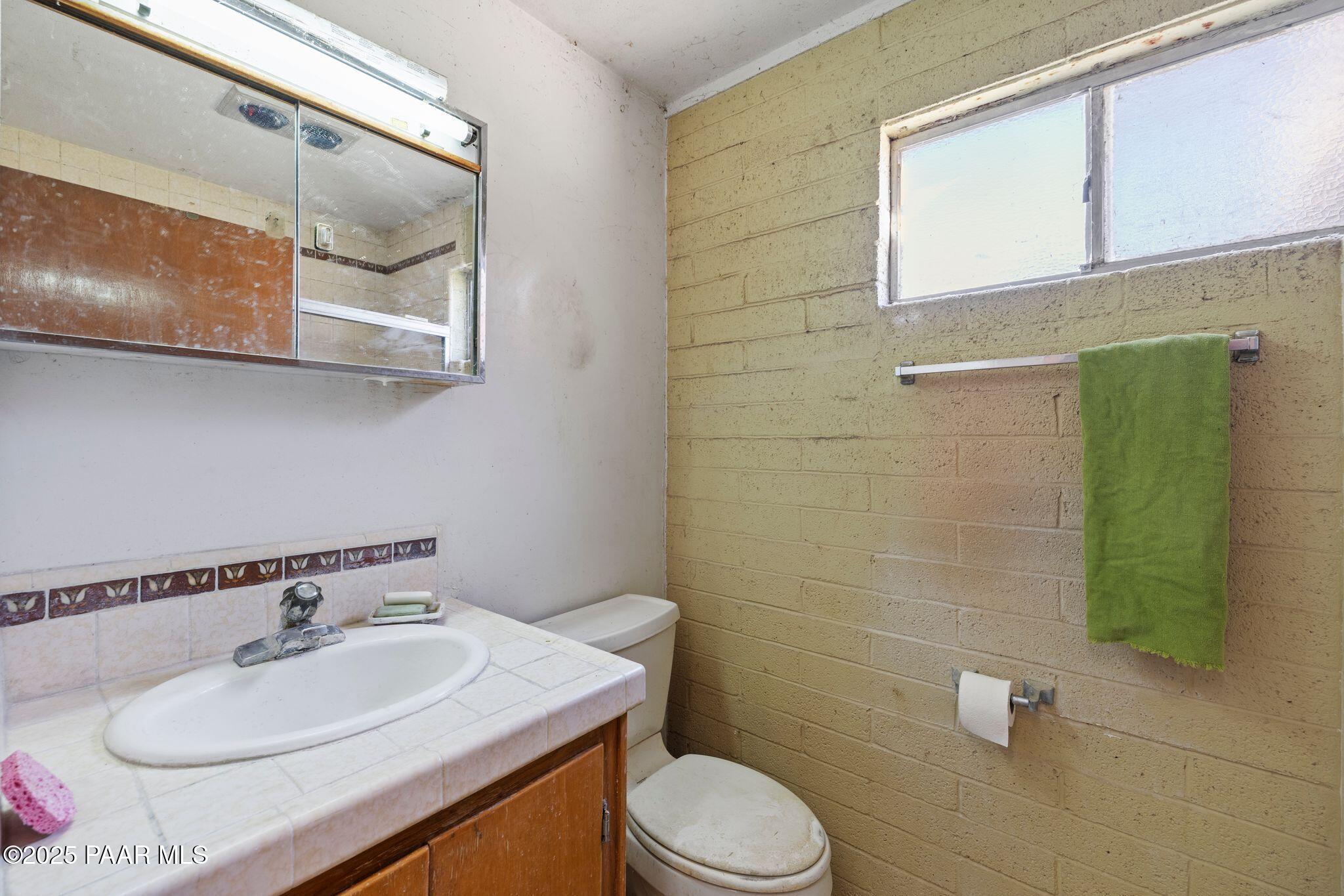 10231 Fir Street Mayer, AZ 86333 - Photo 24 of 50 a bathroom with a sink toilet and mirror
