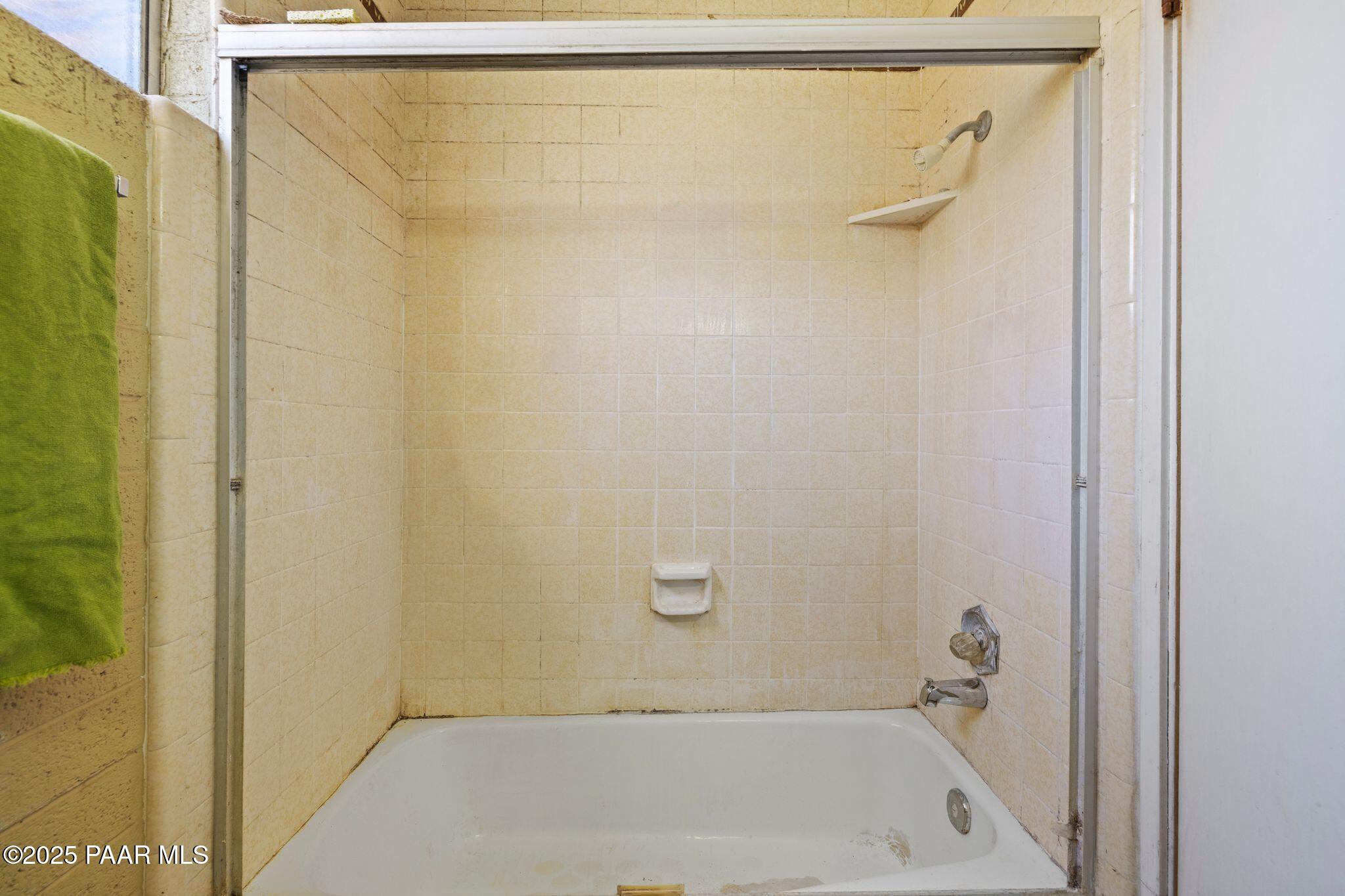 10231 Fir Street Mayer, AZ 86333 - Photo 25 of 50 a bathroom with a shower and a bath tub