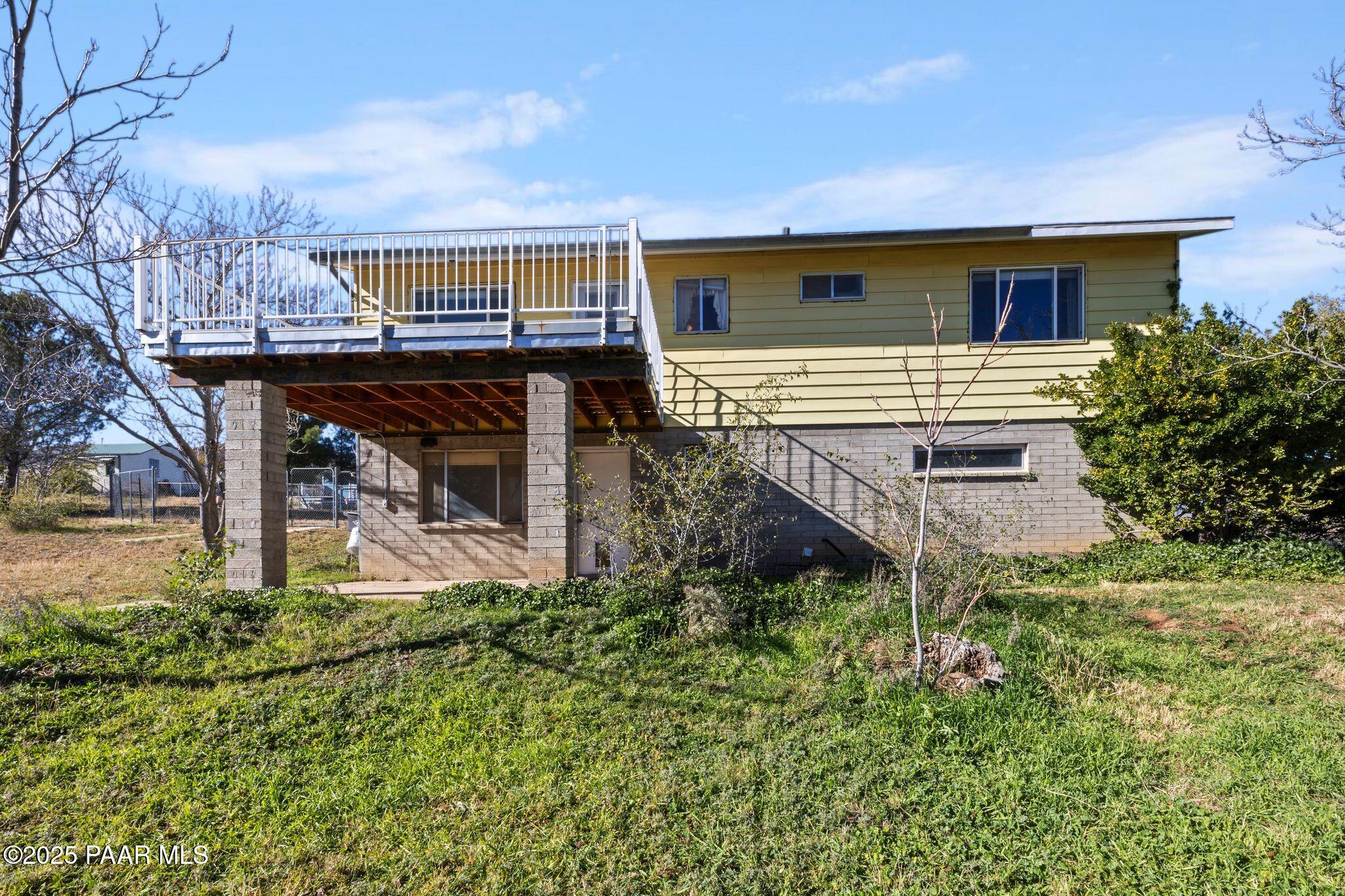 10231 Fir Street Mayer, AZ 86333 - Photo 29 of 50 a view of a house with a small yard and a wooden deck