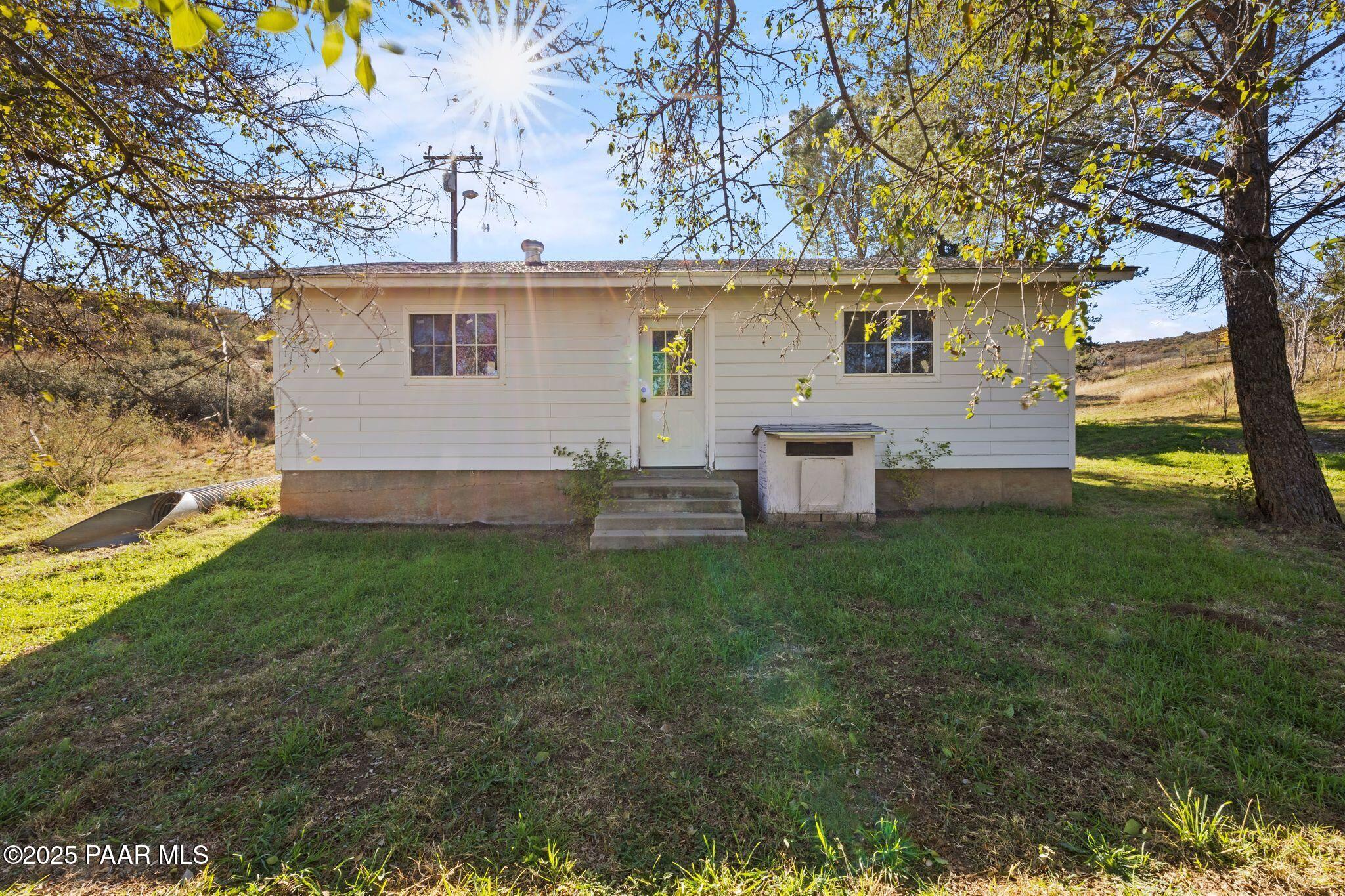 10231 Fir Street Mayer, AZ 86333 - Photo 32 of 50 a view of a backyard with plants and large tree