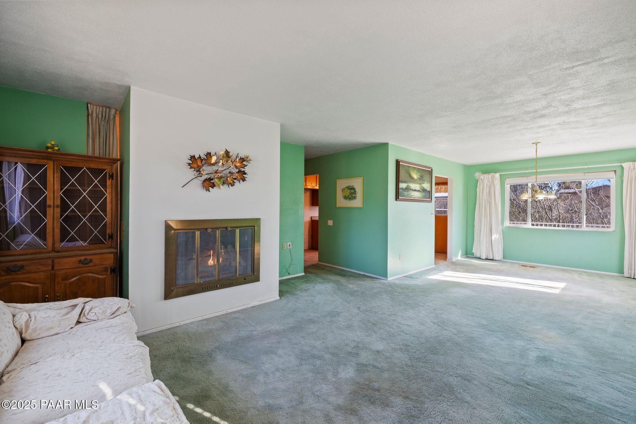 10231 Fir Street Mayer, AZ 86333 - Photo 5 of 50 a view of an empty room with a fireplace