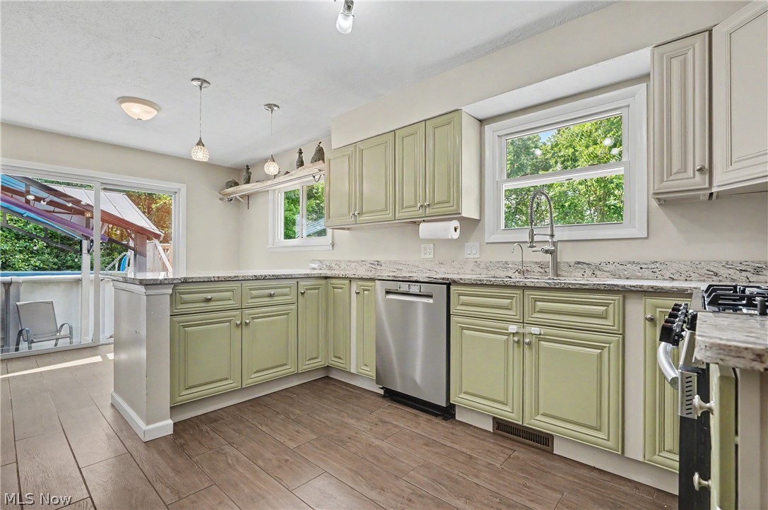 952 Ravenna Road Kent, OH 44240 - Photo 6 of 37 Kitchen featuring granite countertops, stainless steel appliances, plenty of storage and an abundance of light!
