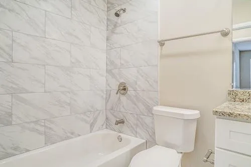 a bathroom with a toilet and shower