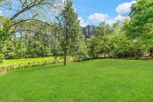 a view of field with an trees