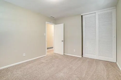 an empty room with closet area