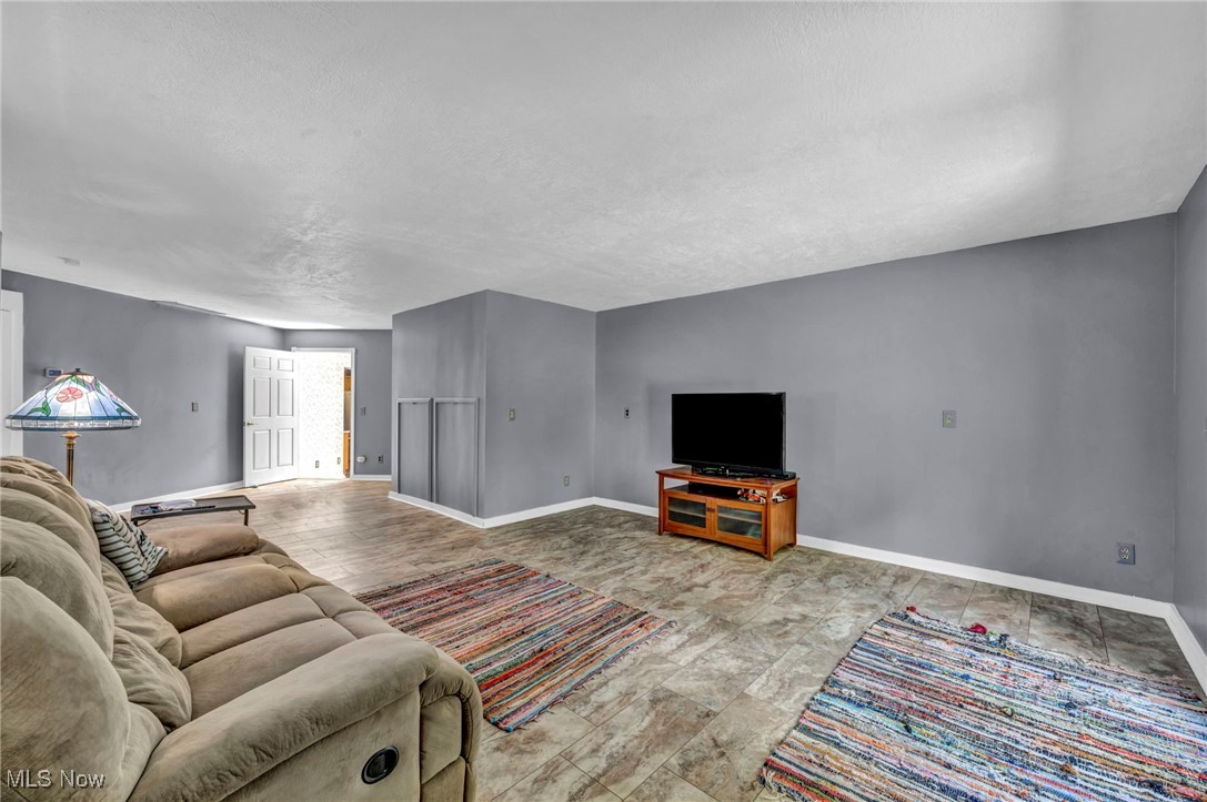 10982 Root Road Columbia Station, OH 44028 - Photo 11 of 49 Living room featuring baseboards and a textured ceiling