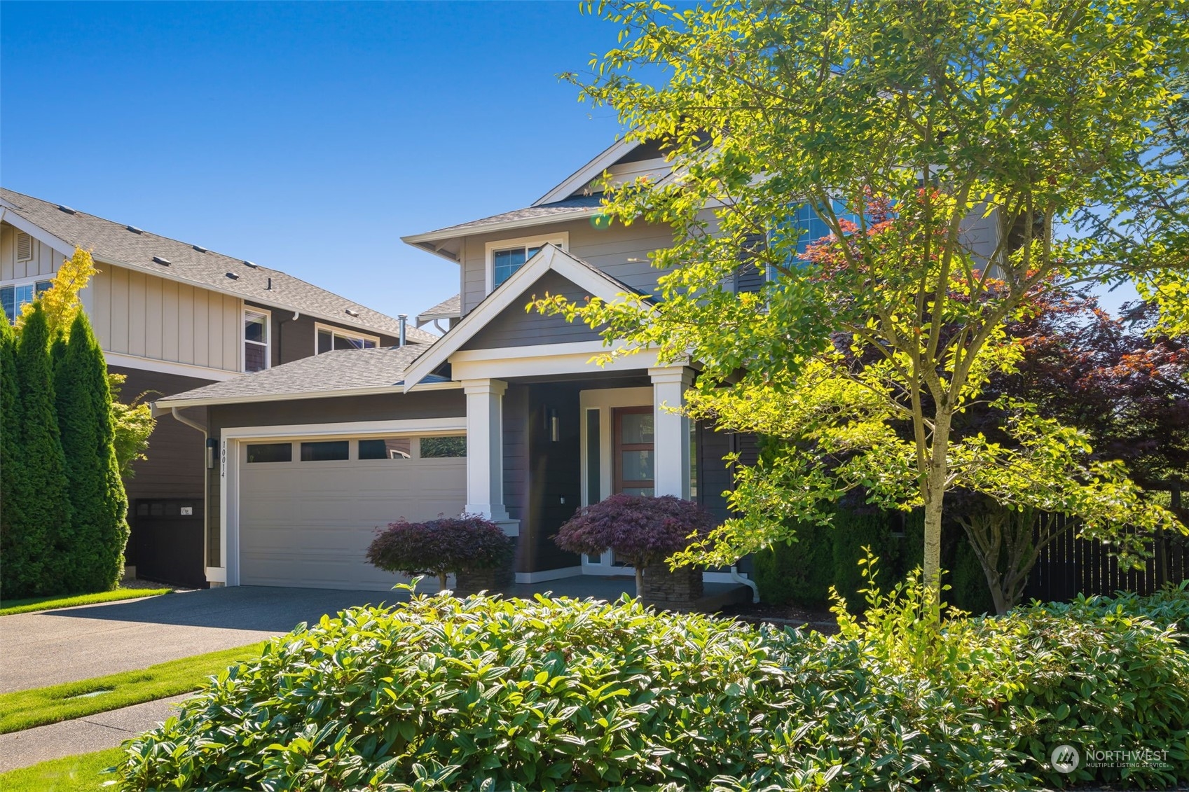 10014 Southeast 192nd Place Renton, WA 98055 - Photo 3 of 35 a front view of a house with a yard