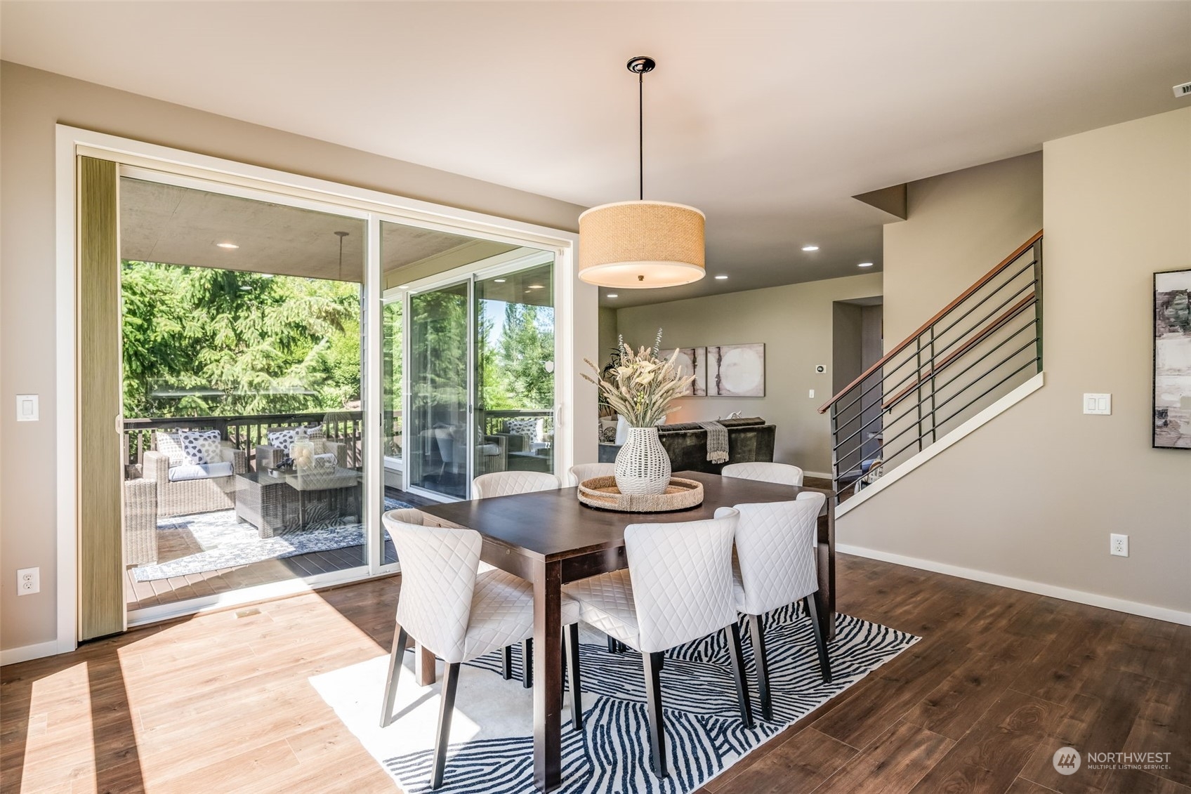 10014 Southeast 192nd Place Renton, WA 98055 - Photo 9 of 35 a view of a dining room and livingroom with furniture wooden floor a chandelier