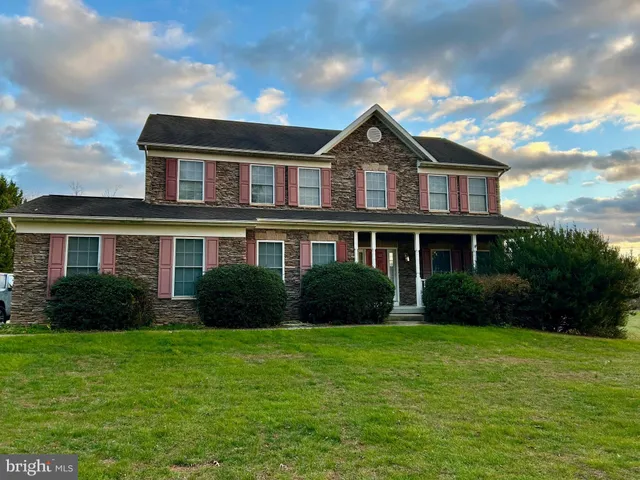 a front view of a house with garden and porch