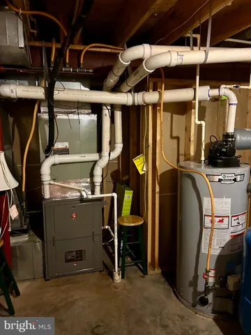 a view of a house with a big yard and large trees