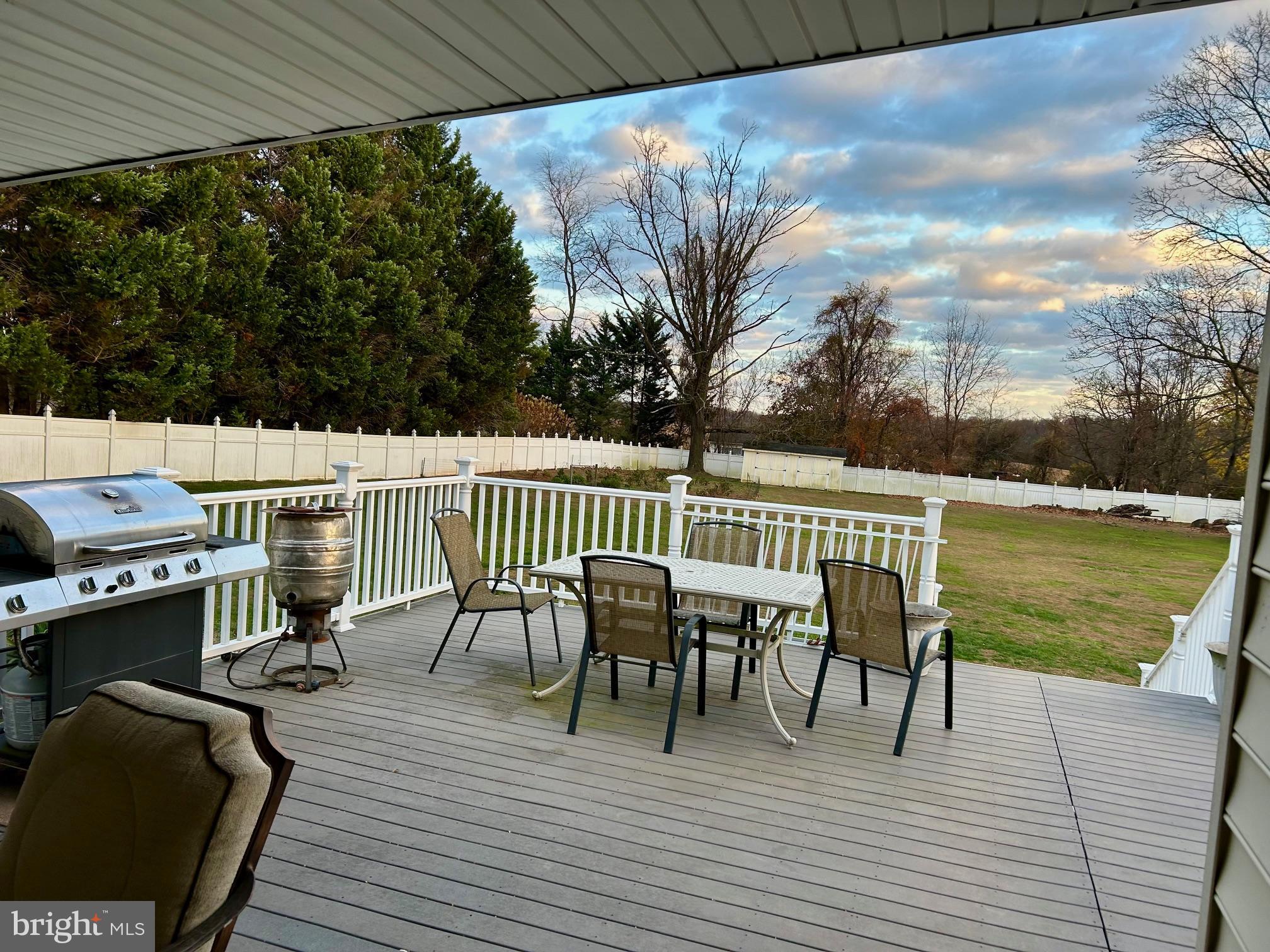 17741 Troyer Road White Hall, MD 21161 - Photo 25 of 26 a view of a patio with table and chairs with wooden floor and fence