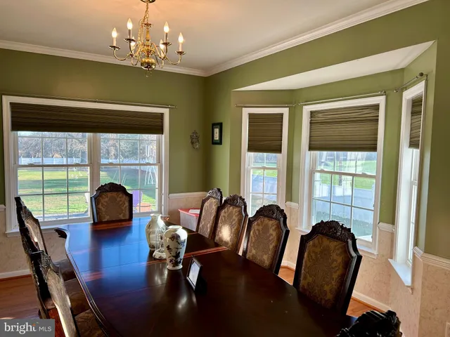 a view of a dining room with furniture and window
