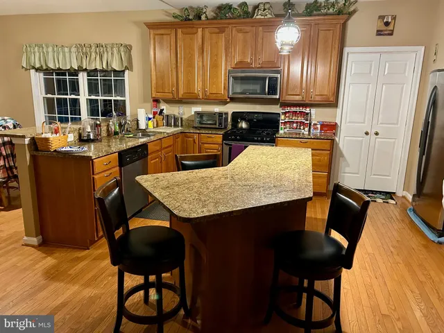 a kitchen with a kitchen island sink stove and microwave