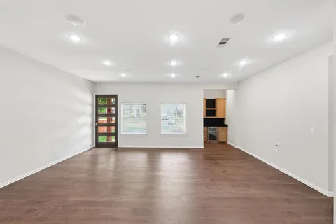 an empty room with wooden floor and closet