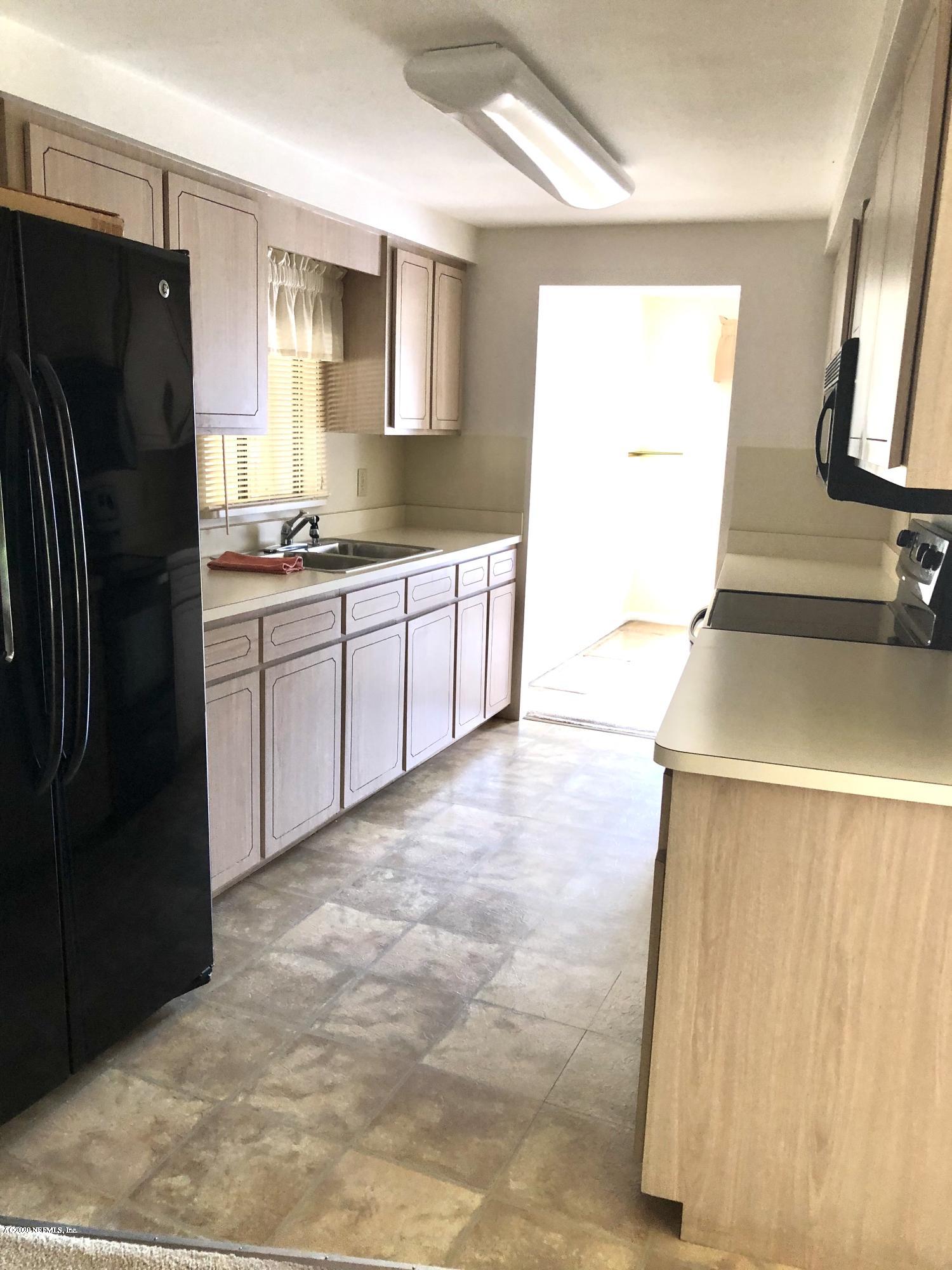 3210 Pacetti Road St. Augustine, FL 32092 - Photo 13 of 17 a kitchen with stainless steel appliances granite countertop a refrigerator a stove and a sink
