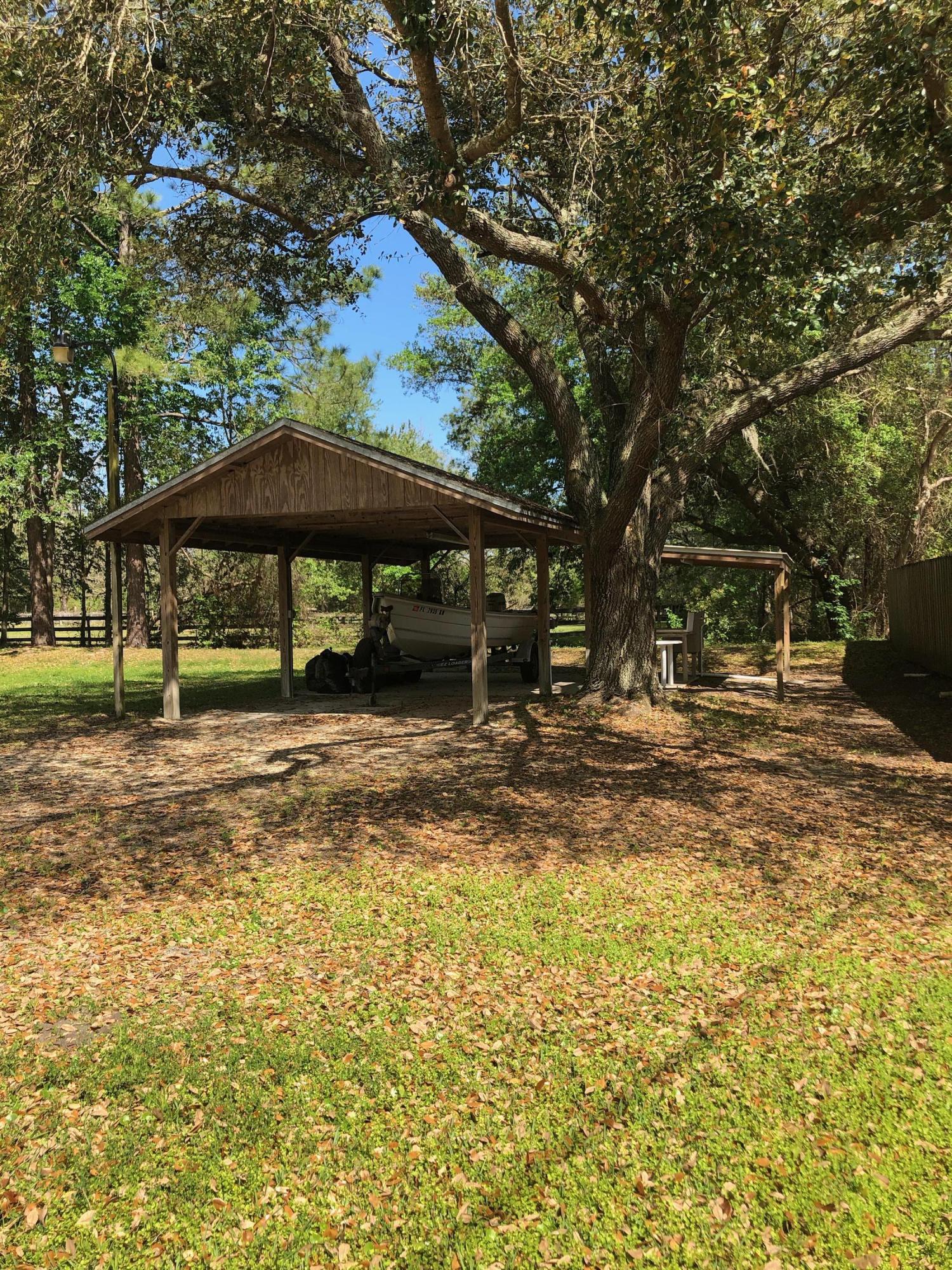 3210 Pacetti Road St. Augustine, FL 32092 - Photo 8 of 17 a view of a table and chairs under an umbrella