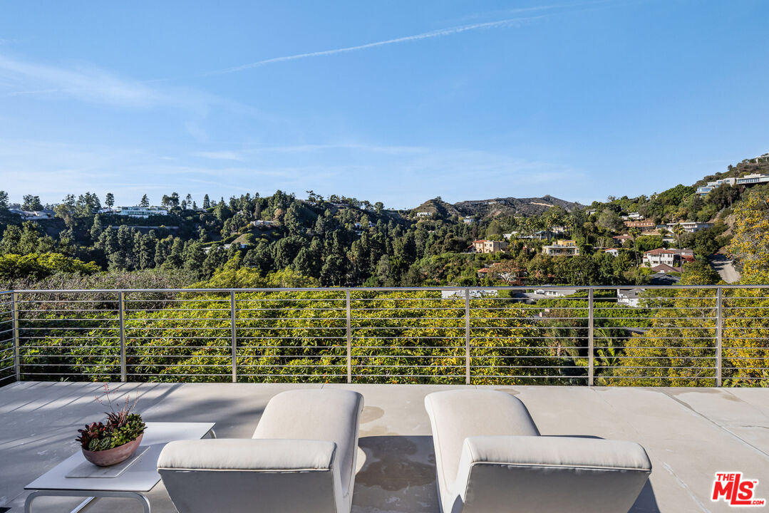 9422 Readcrest Drive Beverly Hills, CA 90210 - Photo 12 of 34 a view of a patio with furniture and a lake view