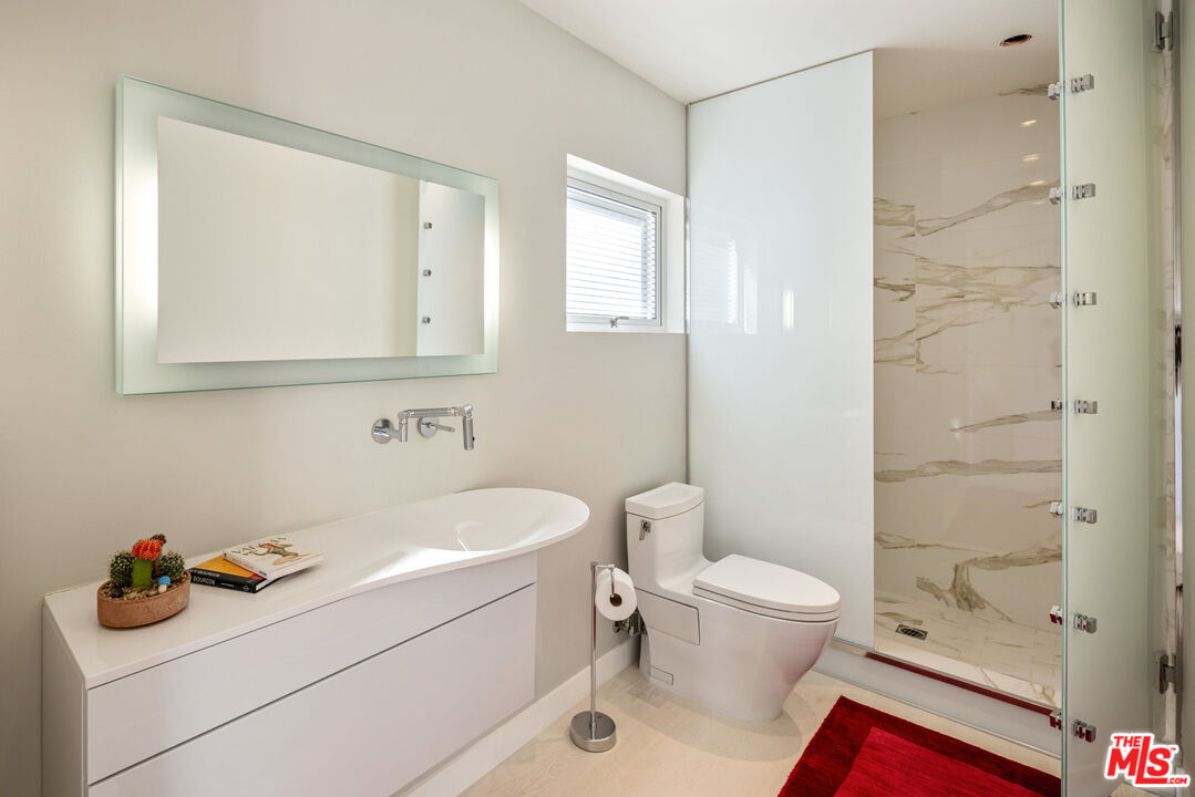 9422 Readcrest Drive Beverly Hills, CA 90210 - Photo 22 of 34 a bathroom with a sink toilet vanity and shower