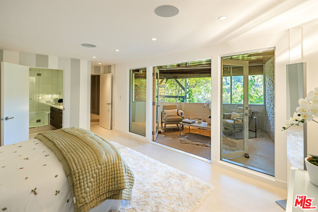 9422 Readcrest Drive Beverly Hills, CA 90210 - Photo 24 of 34 a spacious bedroom with a large bed and a large window