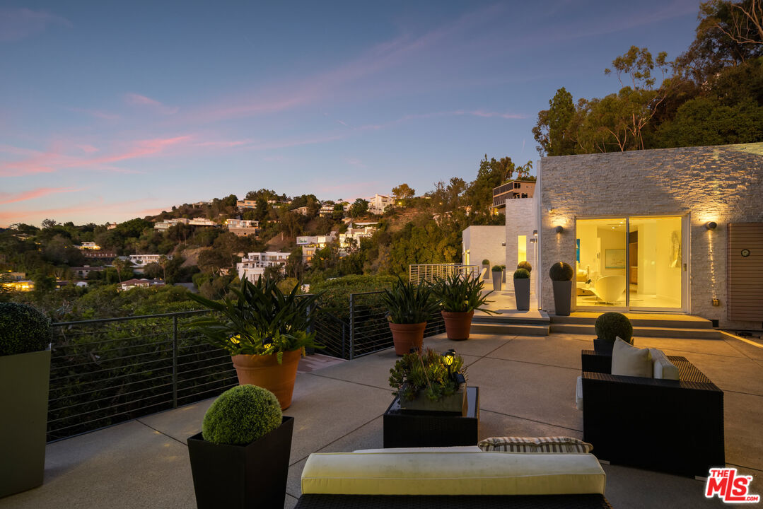 9422 Readcrest Drive Beverly Hills, CA 90210 - Photo 31 of 34 a view of a patio with couches table and chairs and potted plants
