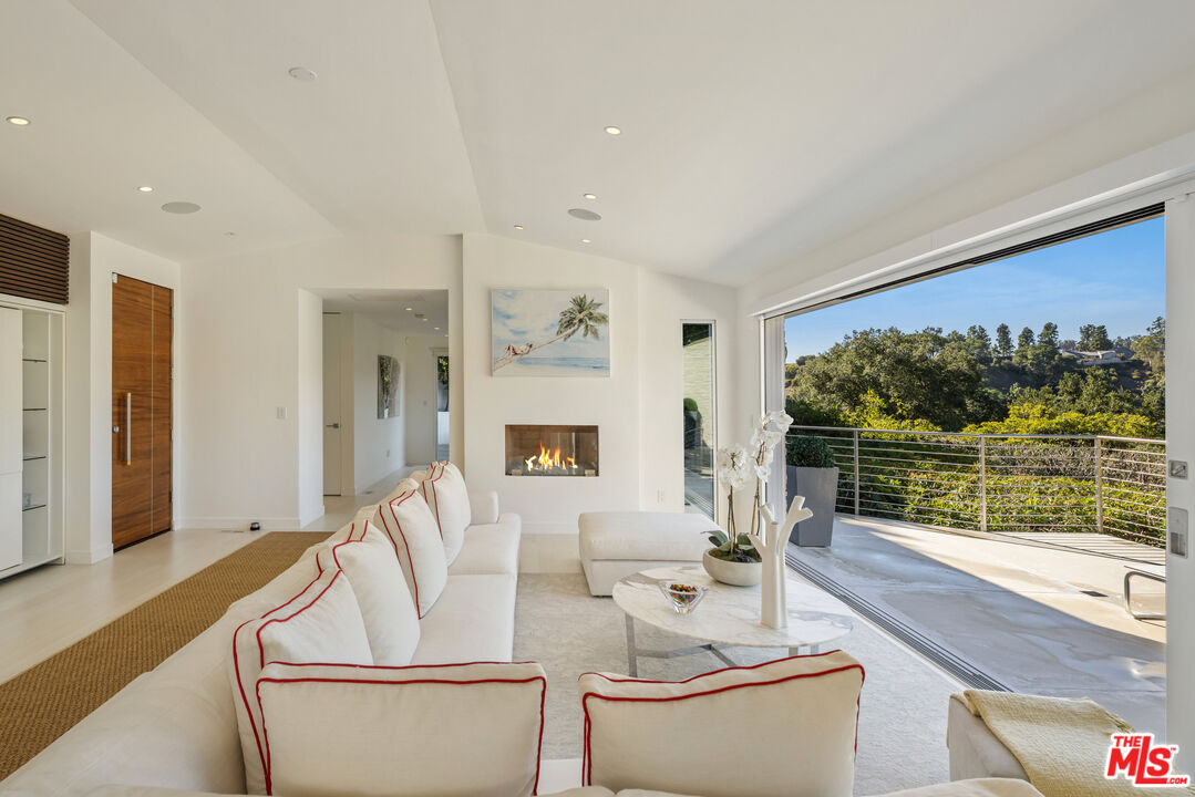 9422 Readcrest Drive Beverly Hills, CA 90210 - Photo 8 of 34 a living room with furniture and a large window