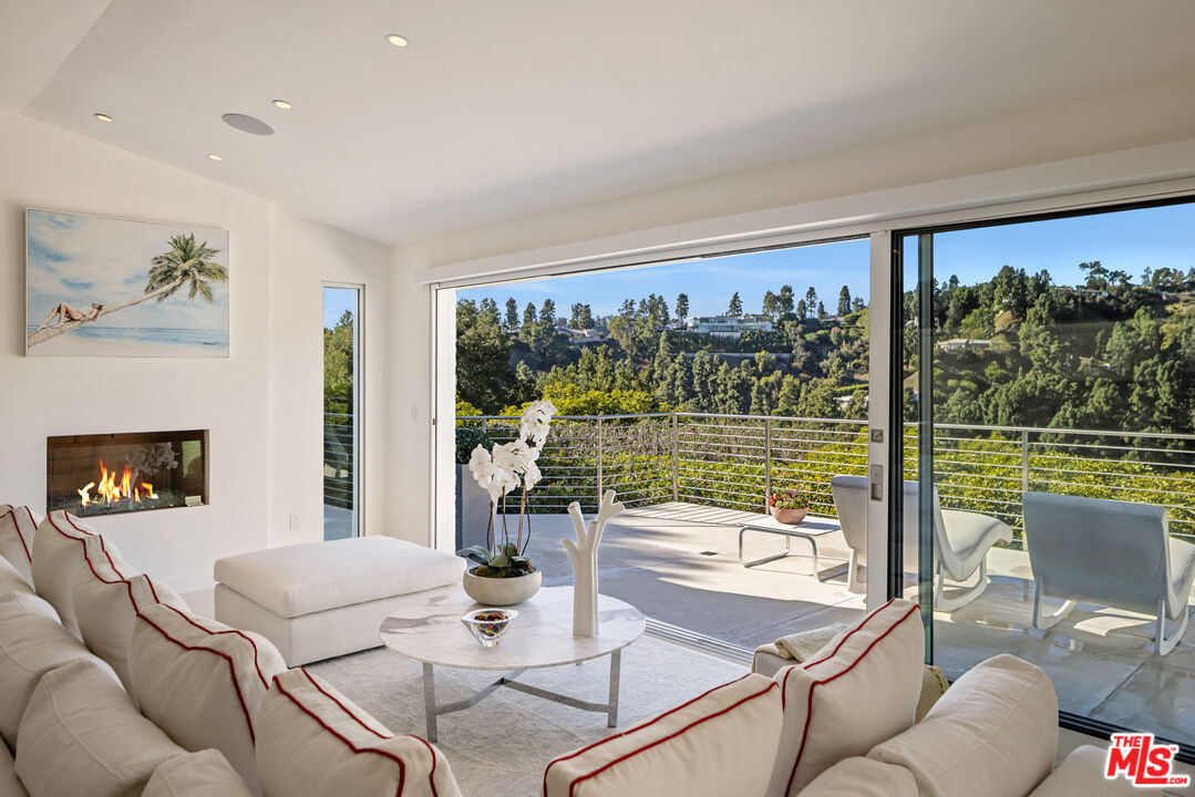 9422 Readcrest Drive Beverly Hills, CA 90210 - Photo 10 of 34 a living room with furniture and a floor to ceiling window