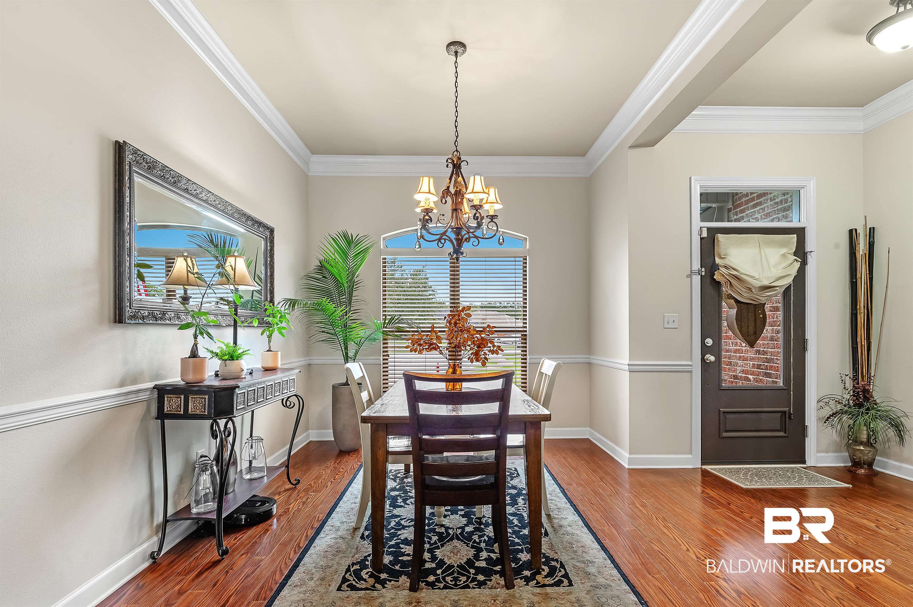 9376 Sable Court Daphne, AL 36526 - Photo 19 of 46 Dining room featuring hardwood / wood-style floors, an inviting chandelier, and crown molding