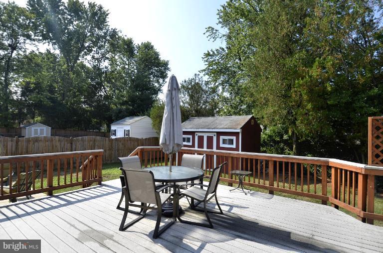 6911 Gilbert Street Springfield, VA 22150 - Photo 8 of 30 a view of a deck with furniture and trees