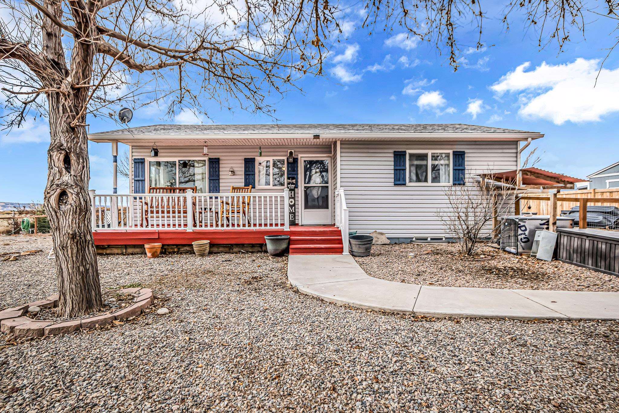 1473 19 Road Fruita, CO 81521 - Photo 1 of 41 a view of a house with a small yard and wooden fence