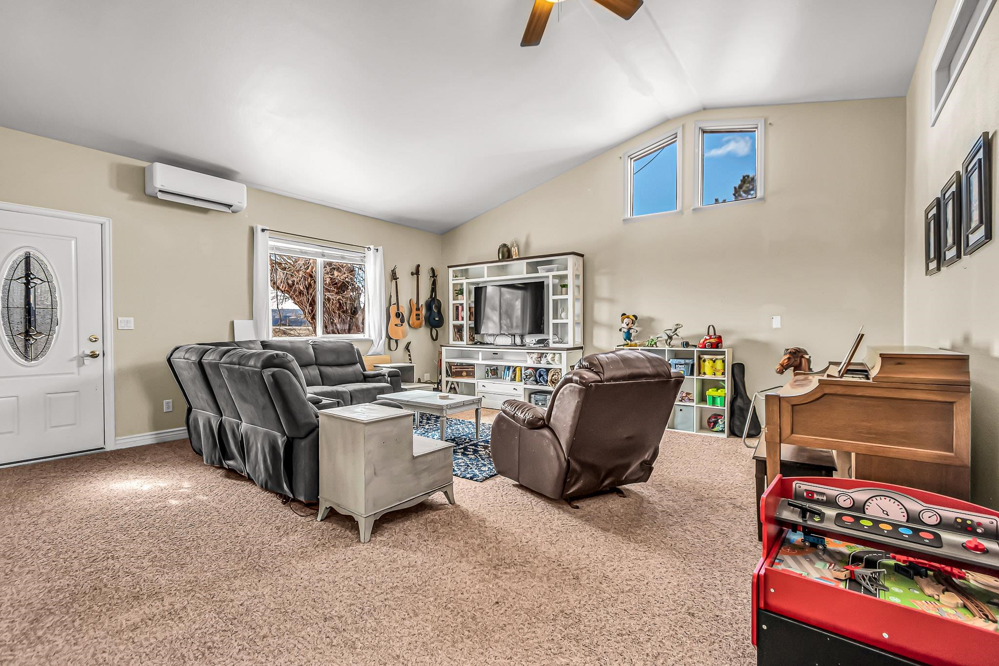 1473 19 Road Fruita, CO 81521 - Photo 12 of 41 a living room with furniture and a flat screen tv