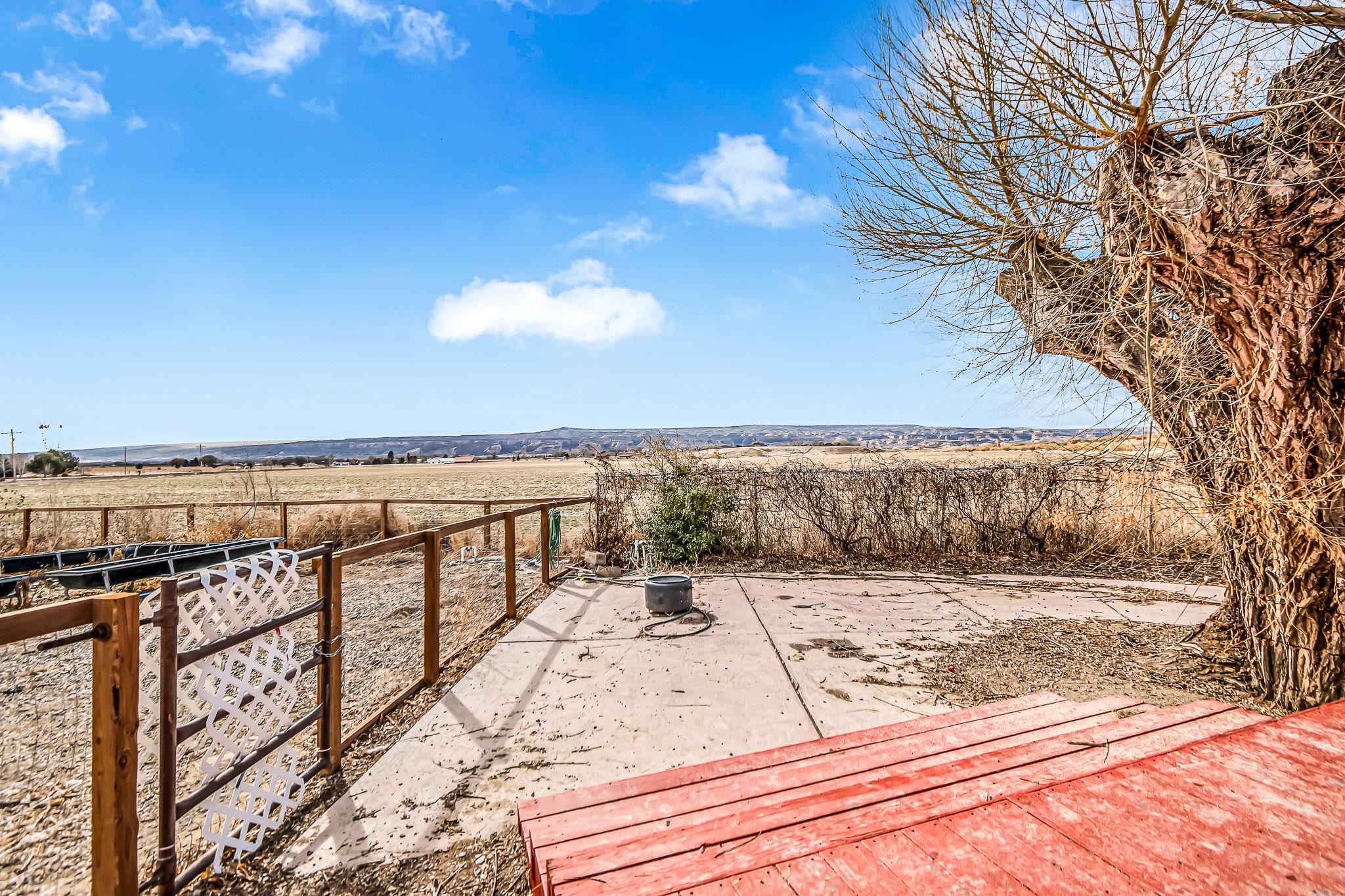 1473 19 Road Fruita, CO 81521 - Photo 14 of 41 a view of a terrace with wooden floor and fence