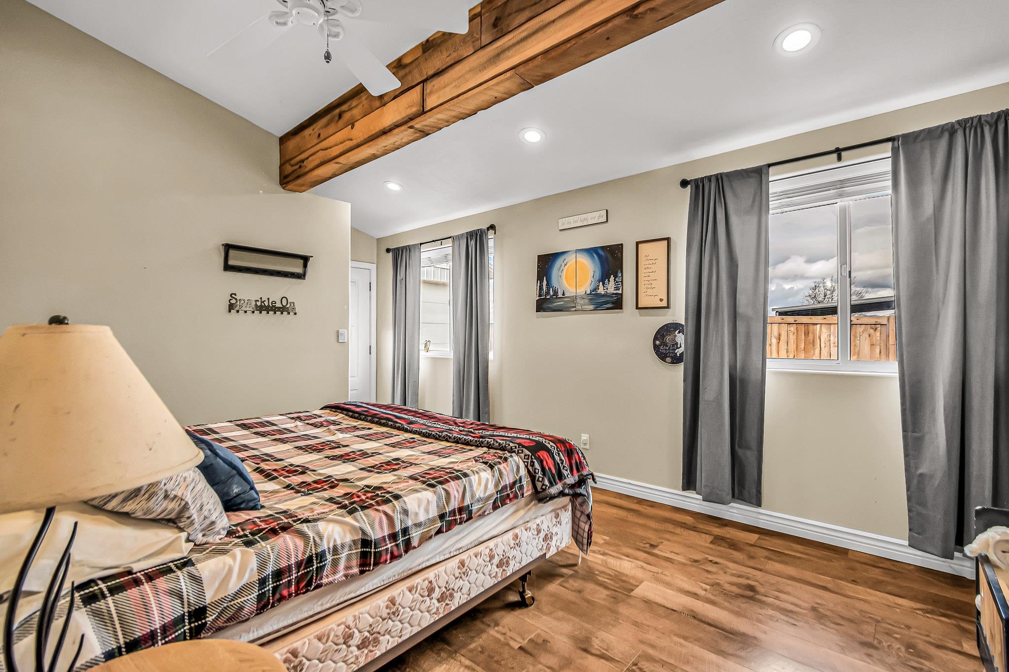 1473 19 Road Fruita, CO 81521 - Photo 16 of 41 a bedroom with a bed and wooden floor