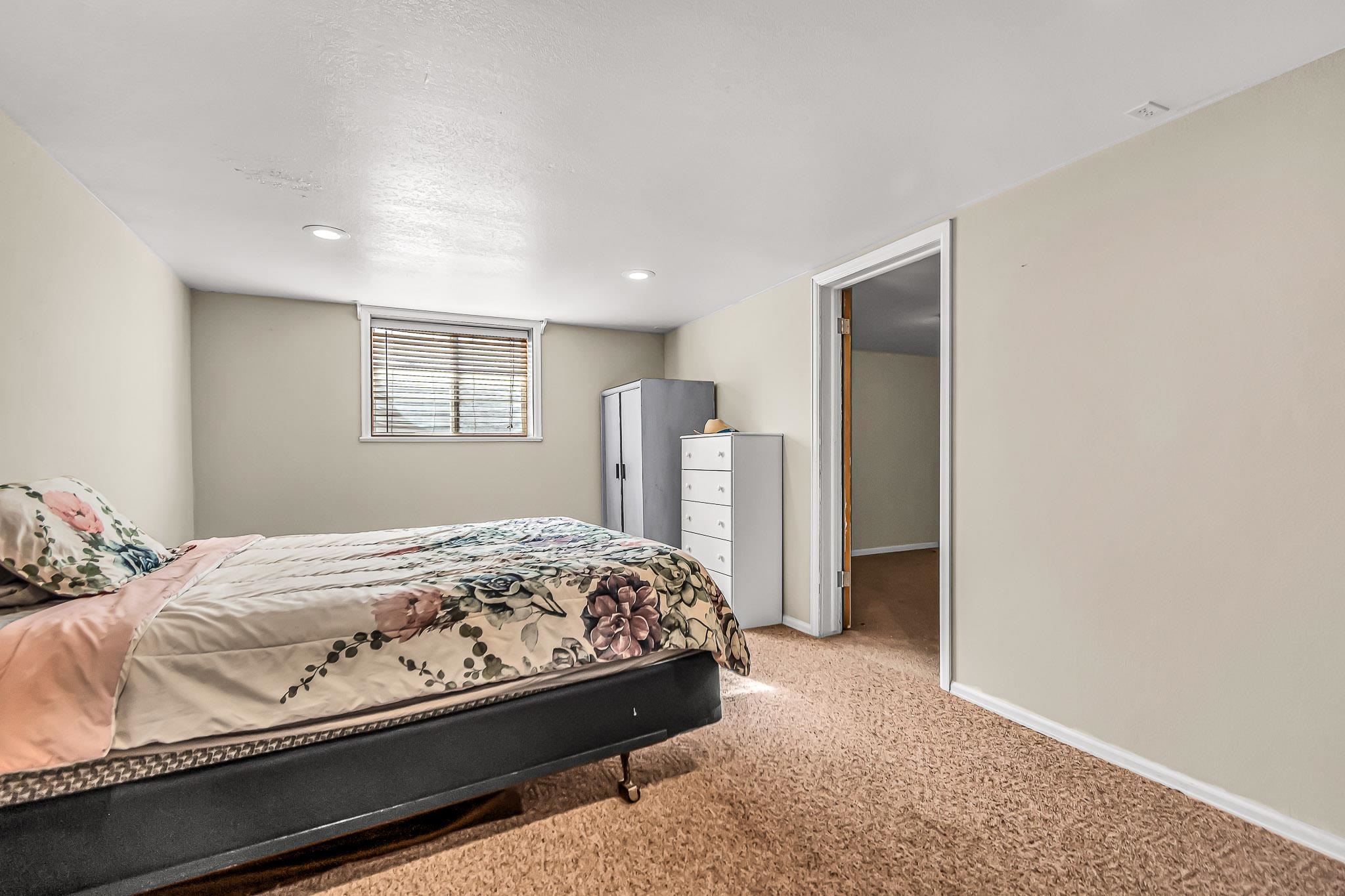 1473 19 Road Fruita, CO 81521 - Photo 23 of 41 a bedroom with a bed and a refrigerator