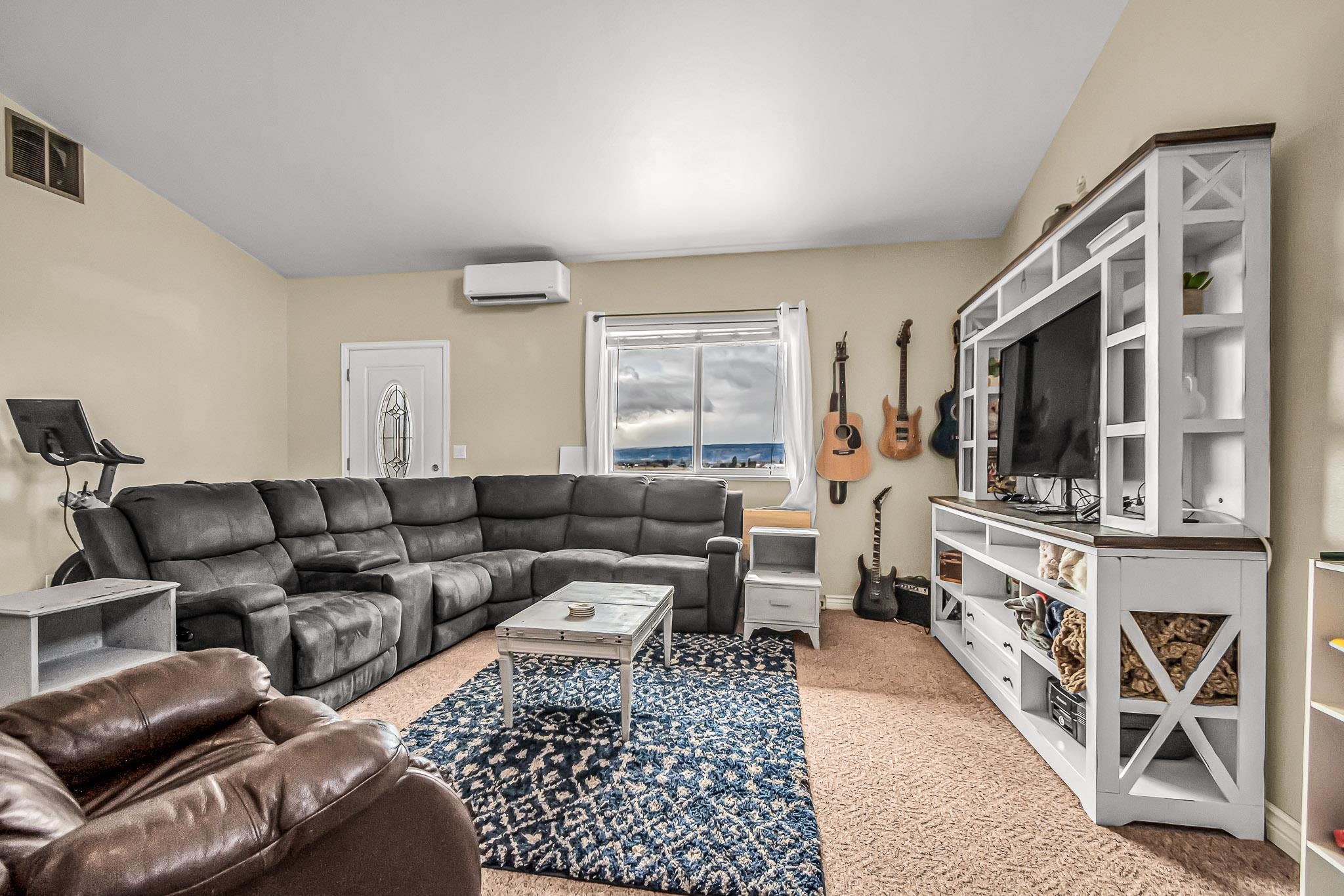 1473 19 Road Fruita, CO 81521 - Photo 33 of 41 a living room with furniture and a flat screen tv