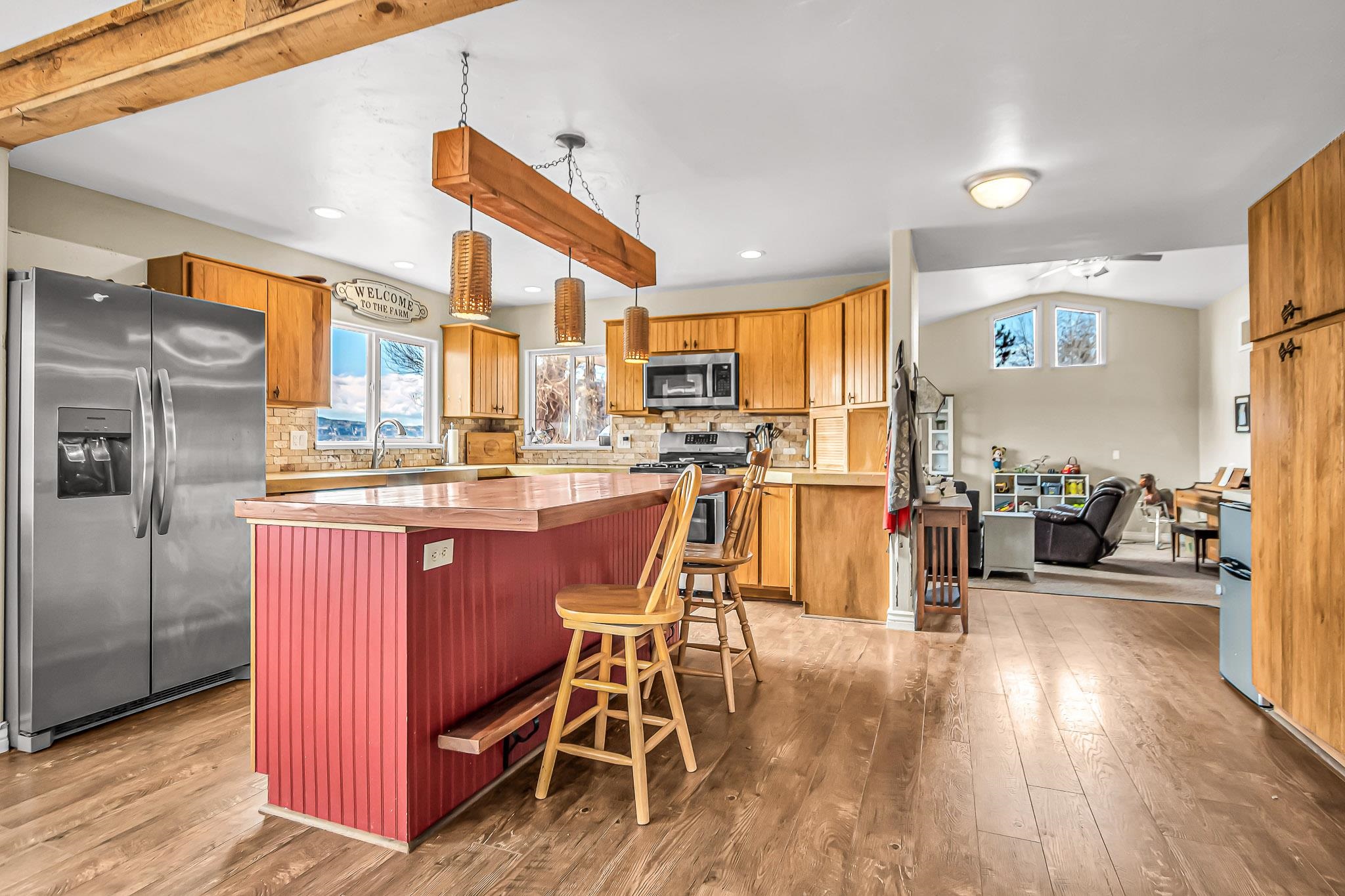 1473 19 Road Fruita, CO 81521 - Photo 6 of 41 a kitchen with stainless steel appliances granite countertop a table chairs refrigerator and sink