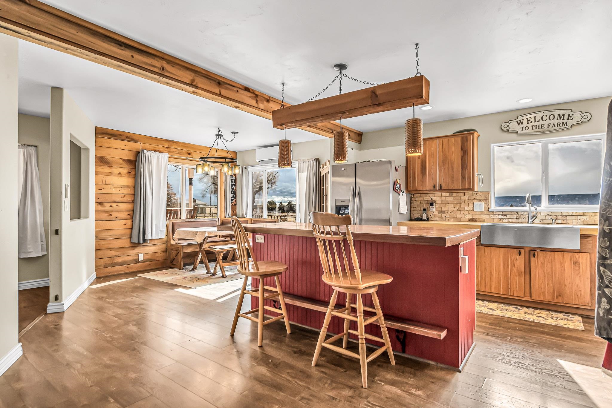 1473 19 Road Fruita, CO 81521 - Photo 10 of 41 a dining room with stainless steel appliances kitchen island granite countertop a table and chairs