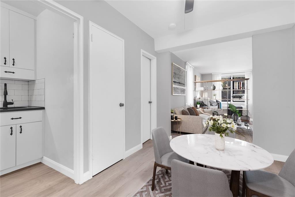7259 Shore Road, Unit 2H Brooklyn, NY 11209 - Photo 5 of 9 a dining room with furniture and wooden floor